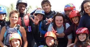 A group of young people in wetsuits